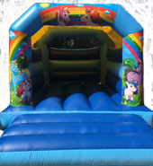 A blue bouncy castle with unicorns on it.
